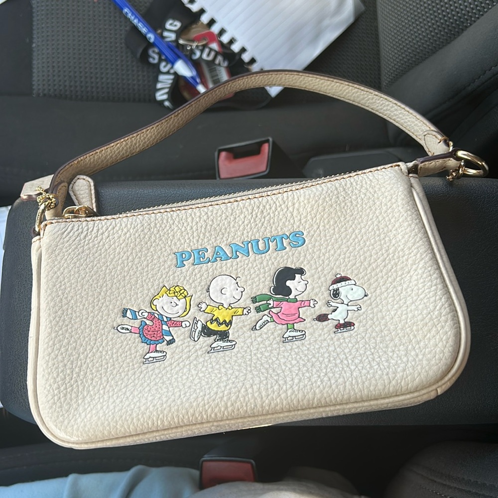 Cream colored Coach x Peanuts purse